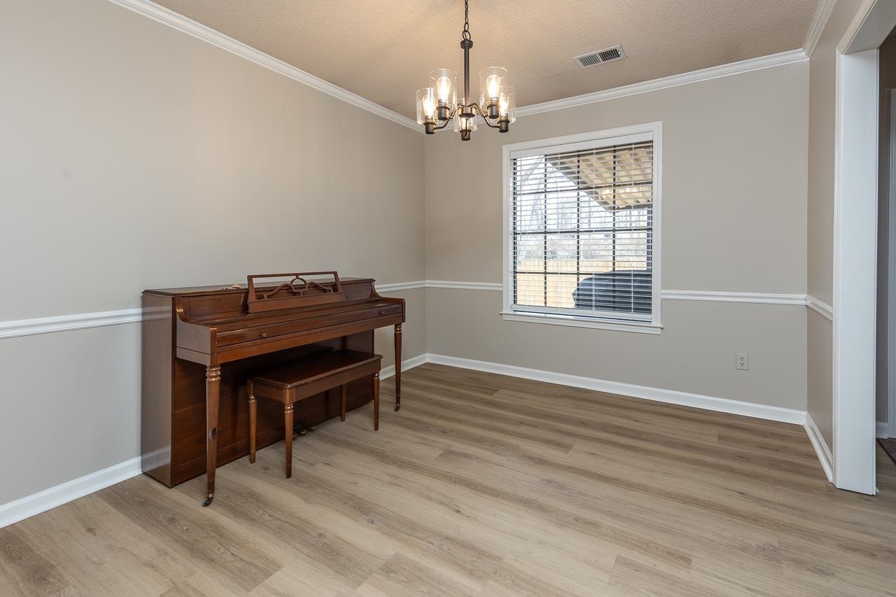 6490 Stone Lake Drive Bartlett, TN 38135 - Photo 13 of 32 a room with furniture and a chandelier