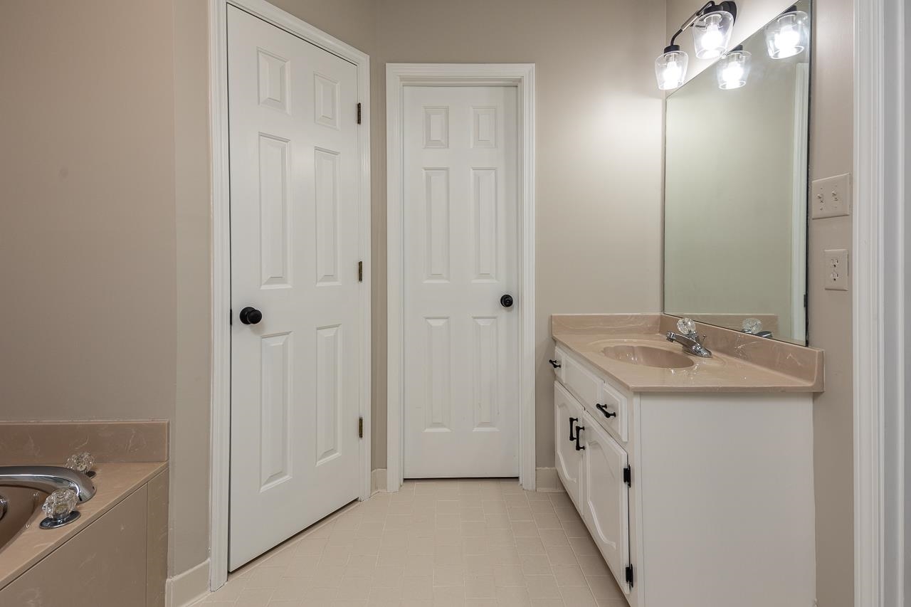 6490 Stone Lake Drive Bartlett, TN 38135 - Photo 20 of 32 a bathroom with a double vanity sink and mirror