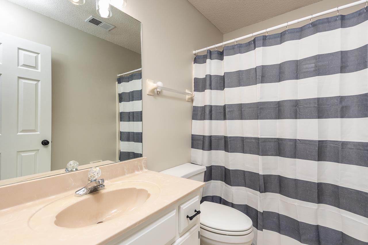 6490 Stone Lake Drive Bartlett, TN 38135 - Photo 23 of 32 a bathroom with a sink a toilet a shower and a mirror