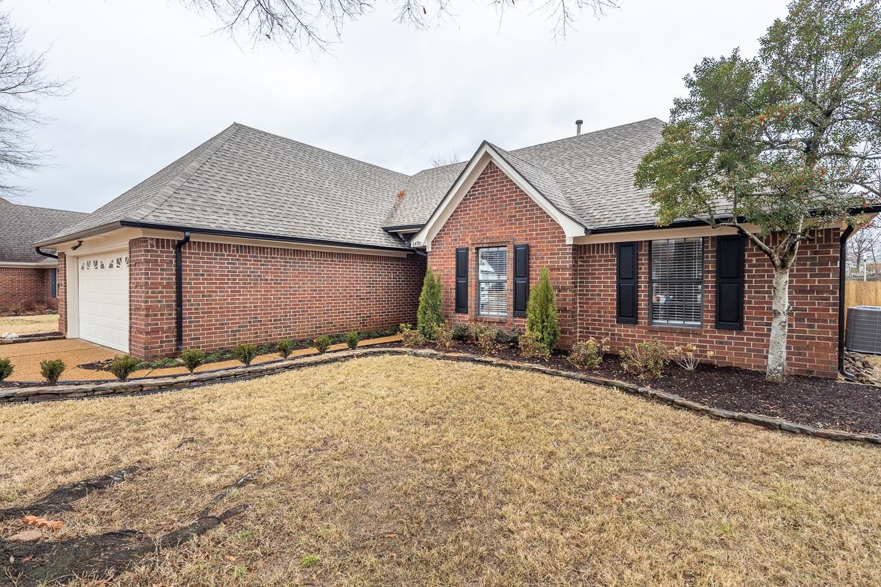 6490 Stone Lake Drive Bartlett, TN 38135 - Photo 3 of 32 a front view of a house with a yard and garage