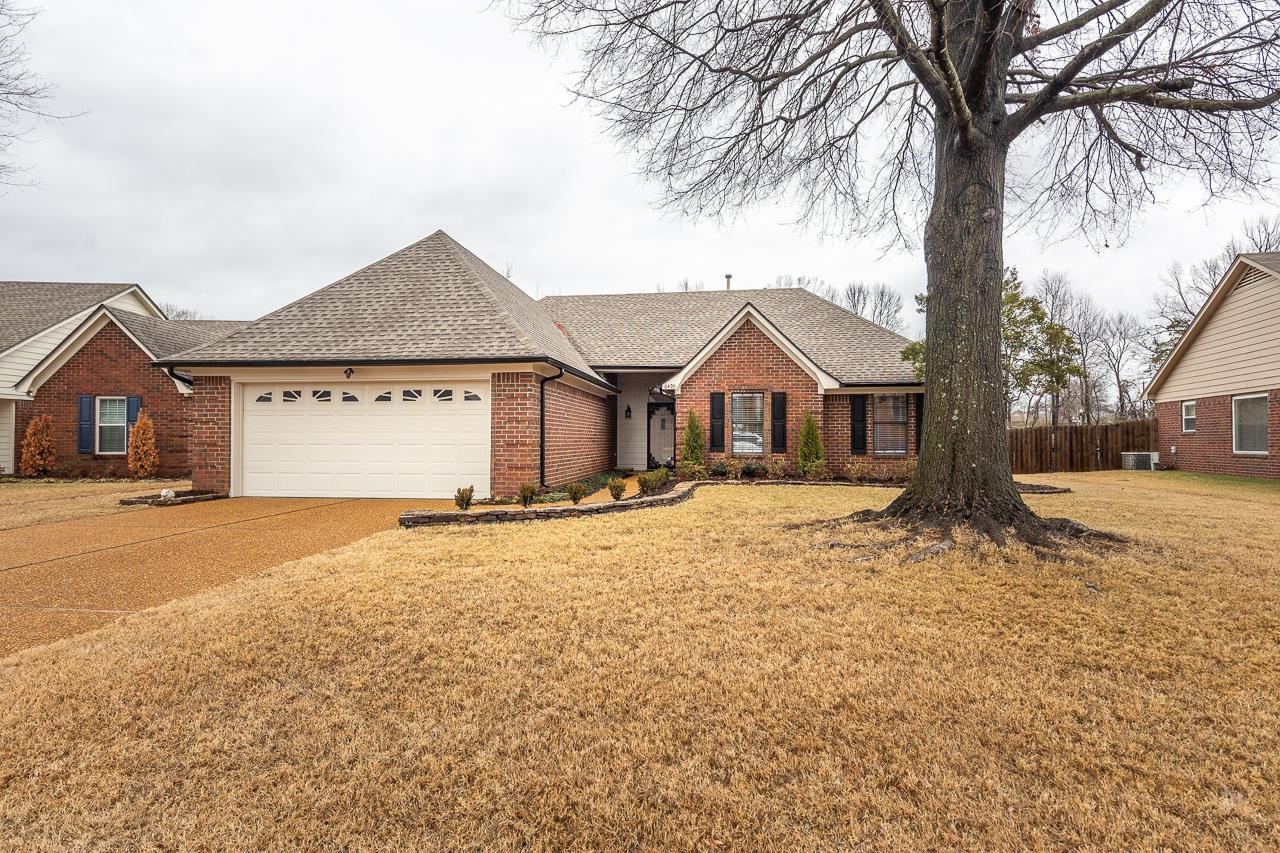 6490 Stone Lake Drive Bartlett, TN 38135 - Photo 4 of 32 a front view of a house with a yard and garage