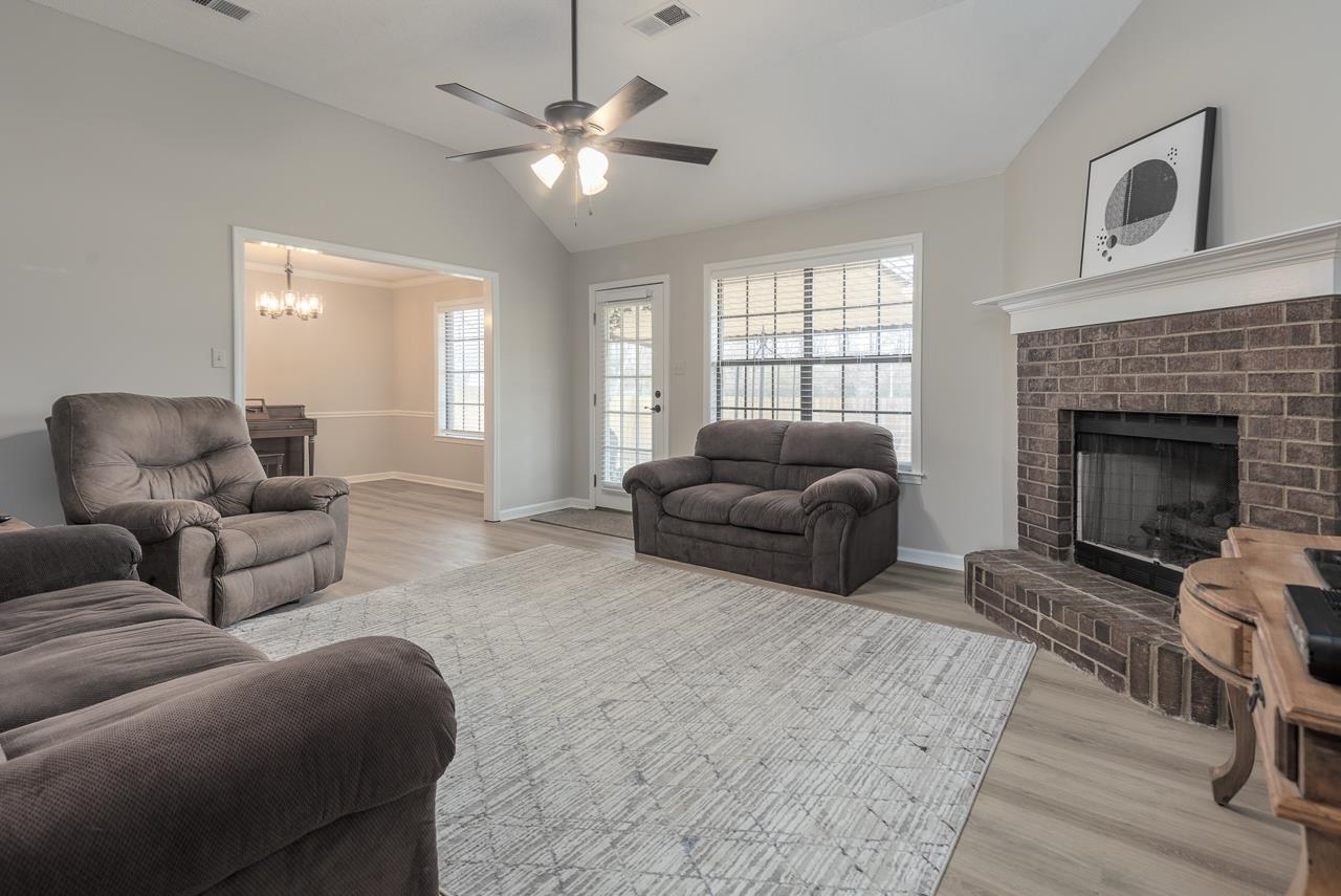 6490 Stone Lake Drive Bartlett, TN 38135 - Photo 6 of 32 a living room with furniture a fireplace and a flat screen tv