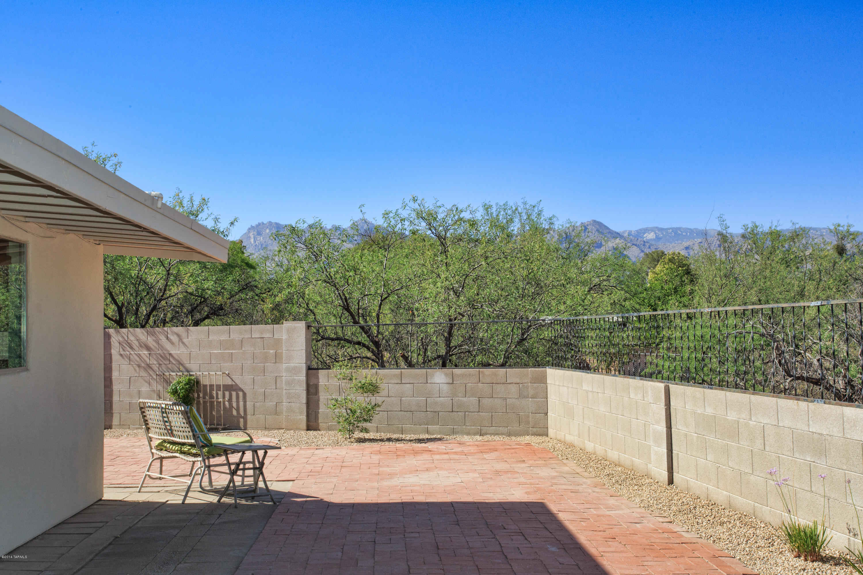 3240 North Webster Road Tucson, AZ 85750 - Photo 23 of 26 a view of a patio with a table and chairs under an umbrella