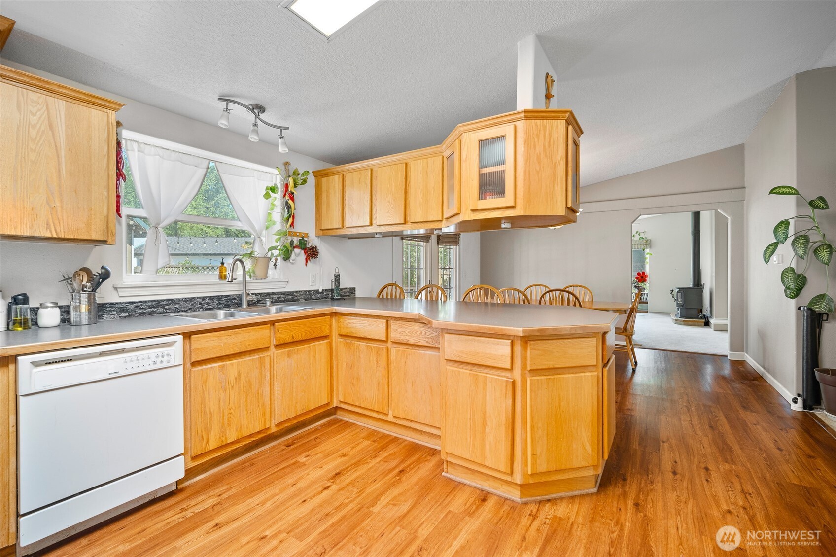 4230 Cody Road Blaine, WA 98230 - Photo 13 of 38 a kitchen with granite countertop a sink cabinets and window
