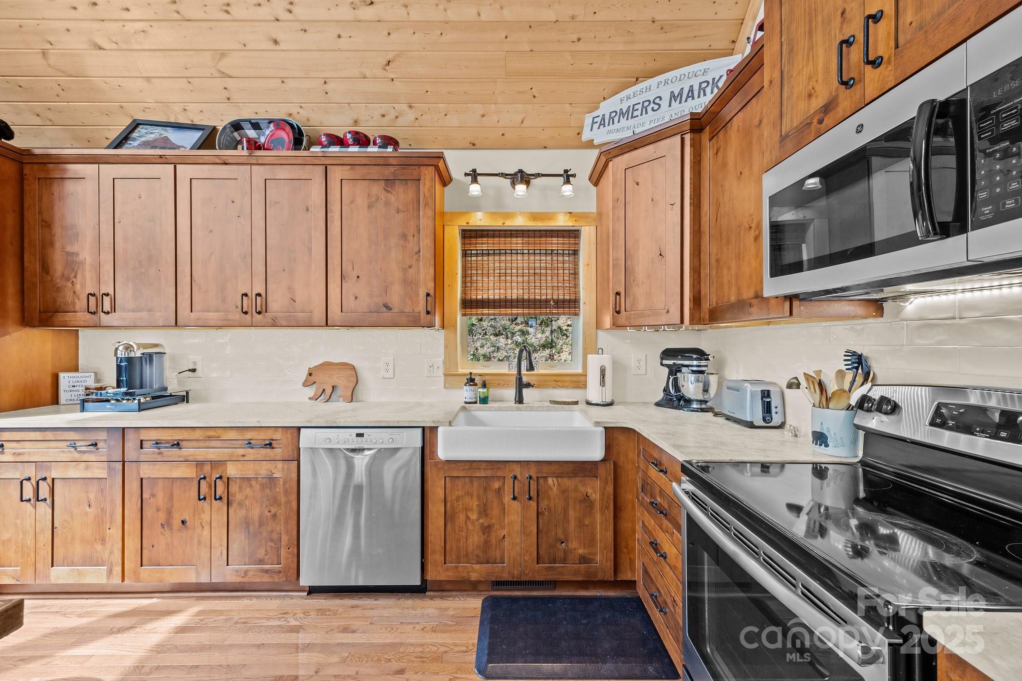 1954 Utah Mountain Road Waynesville, NC 28785 - Photo 19 of 39 a kitchen with stainless steel appliances granite countertop a stove and a sink