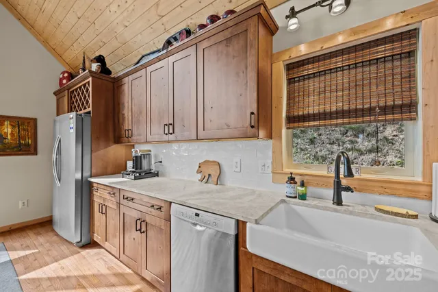 a kitchen with stainless steel appliances a sink a stove and a refrigerator