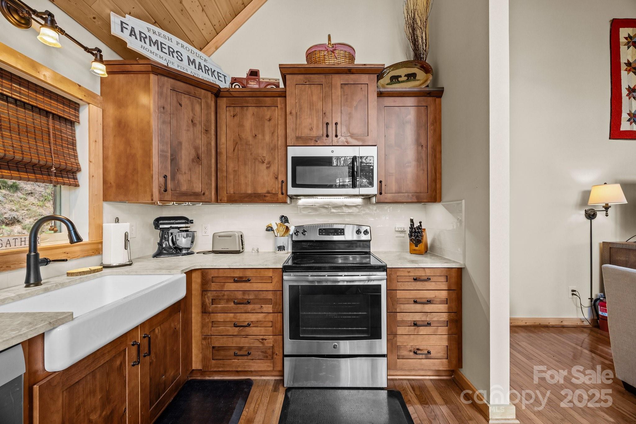 1954 Utah Mountain Road Waynesville, NC 28785 - Photo 21 of 39 a kitchen with stainless steel appliances kitchen island granite countertop a stove top oven a sink and dishwasher