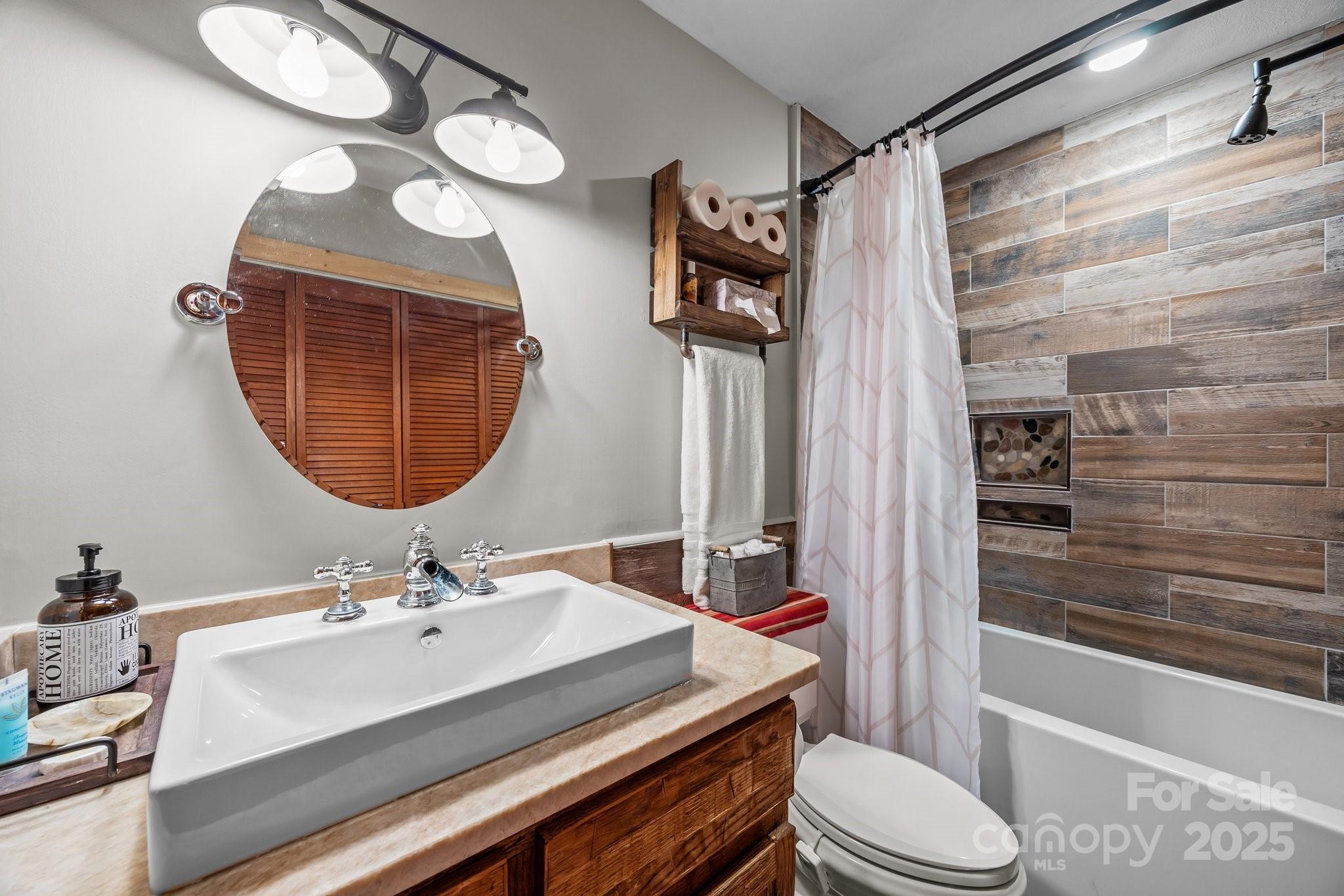 1954 Utah Mountain Road Waynesville, NC 28785 - Photo 22 of 39 a bathroom with a sink a toilet and shower