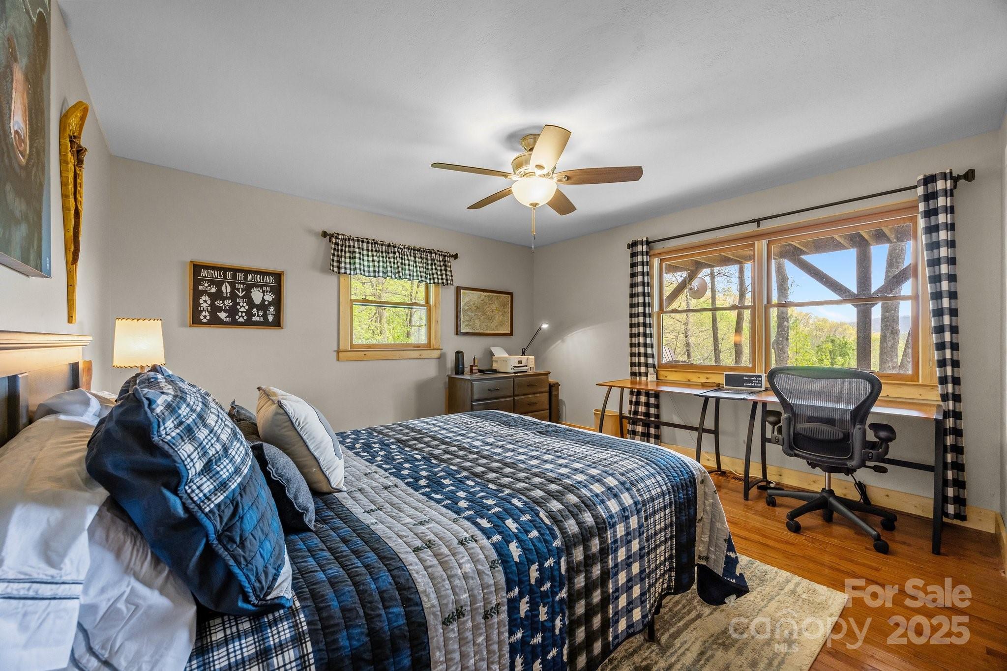 1954 Utah Mountain Road Waynesville, NC 28785 - Photo 27 of 39 a bedroom with a bed and a chandelier