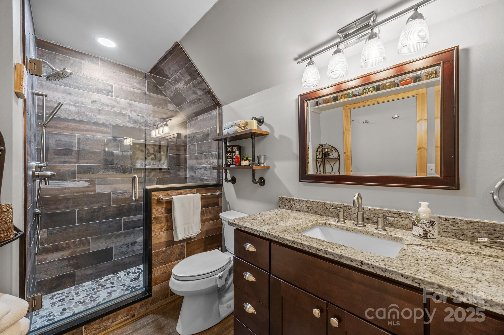 1954 Utah Mountain Road Waynesville, NC 28785 - Photo 29 of 39 a bathroom with a granite countertop sink toilet and shower