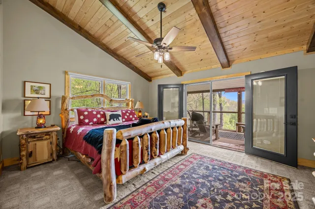 a bedroom with a large bed and a chandelier