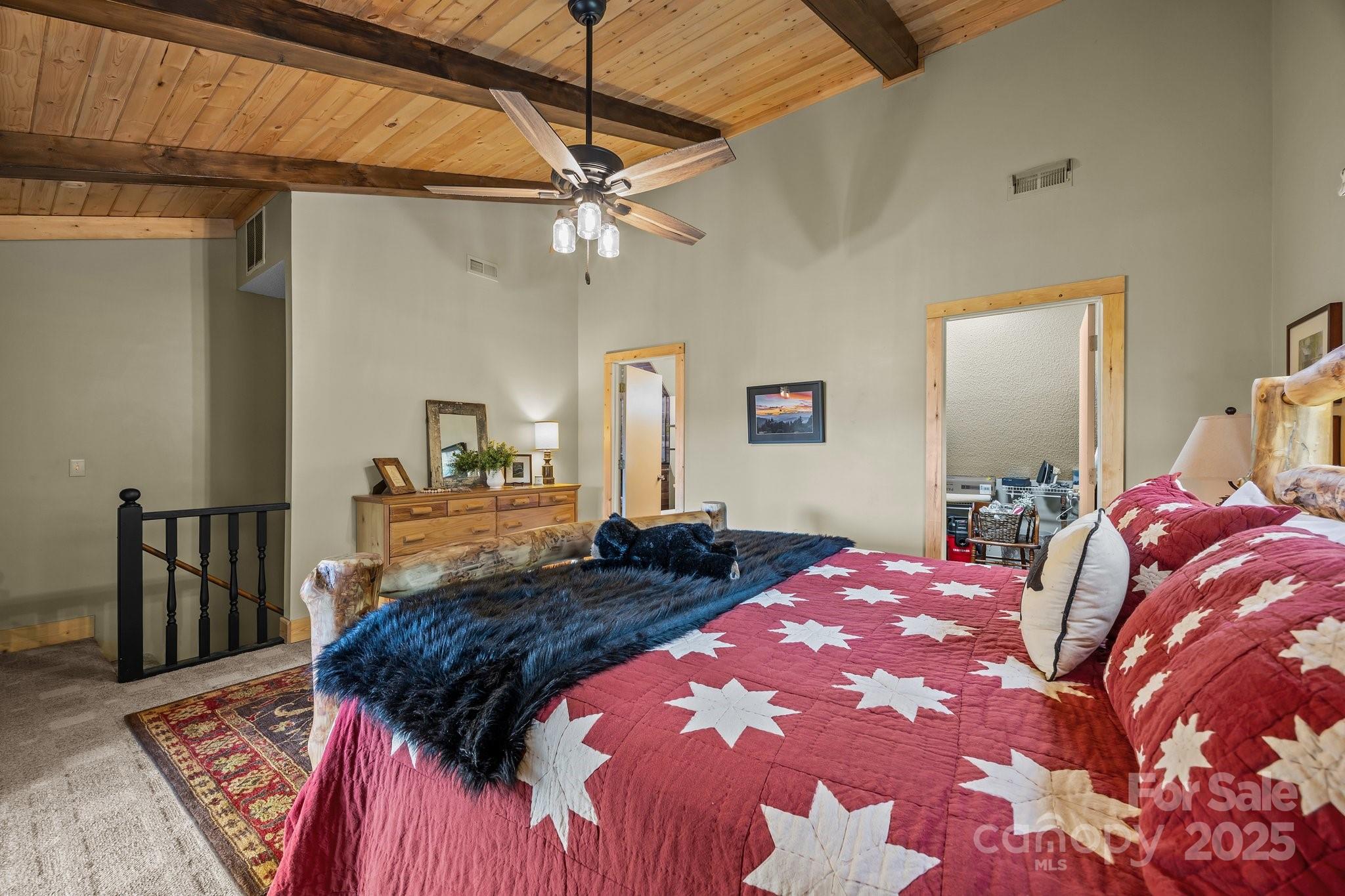 1954 Utah Mountain Road Waynesville, NC 28785 - Photo 31 of 39 a bedroom with a large bed and a chandelier
