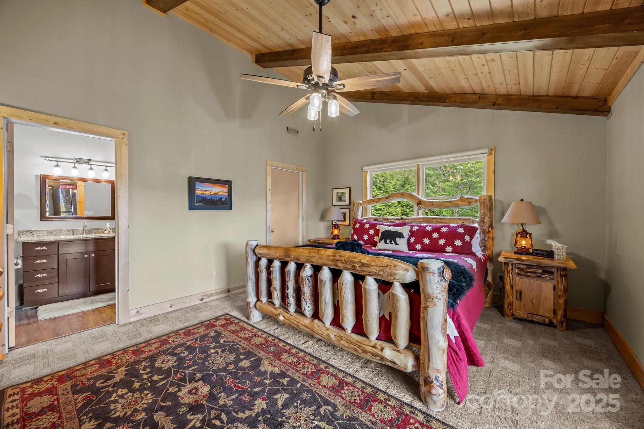 1954 Utah Mountain Road Waynesville, NC 28785 - Photo 32 of 39 a bed room with a bed and a chandelier