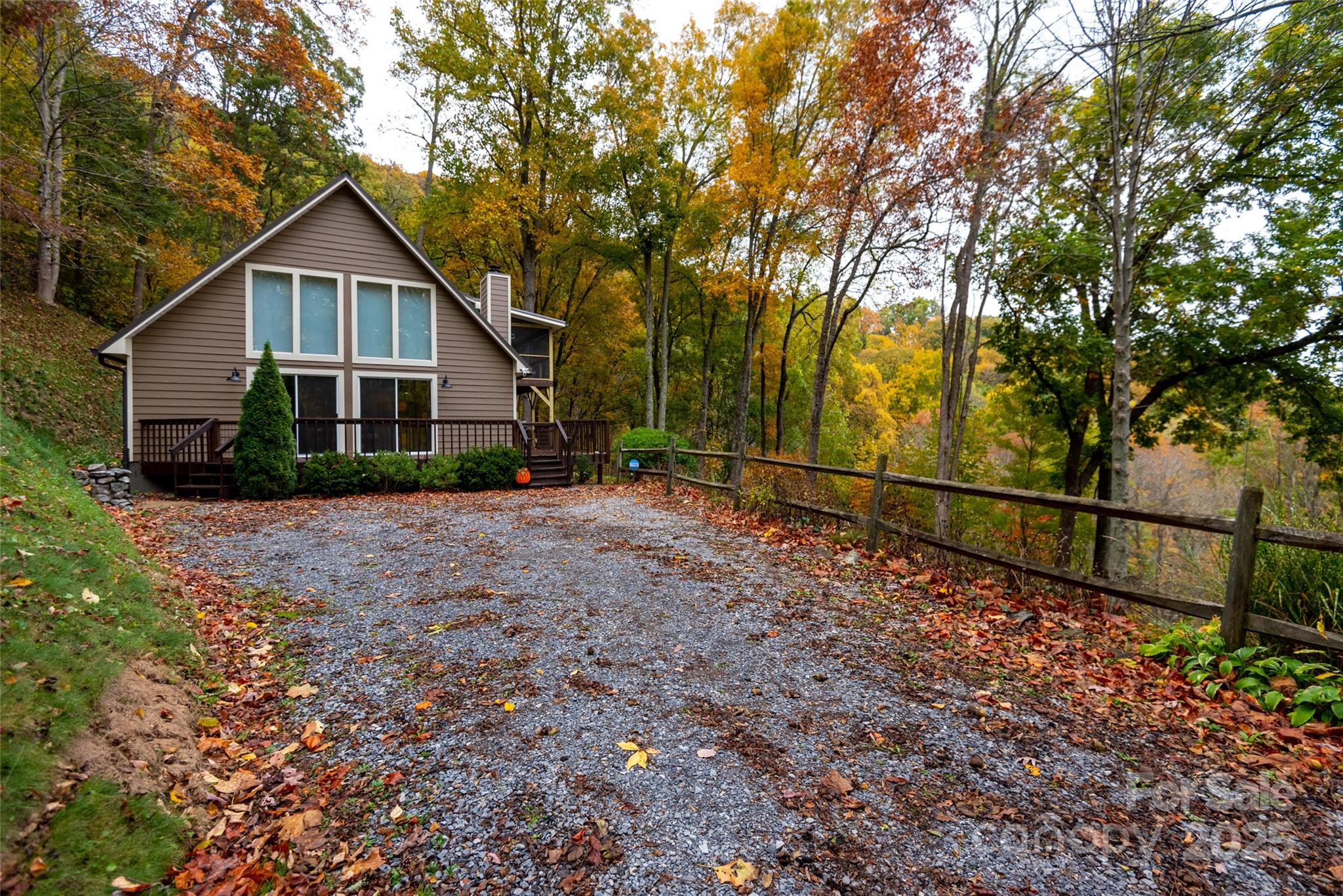 1954 Utah Mountain Road Waynesville, NC 28785 - Photo 4 of 39 a view of house with a yard and large trees