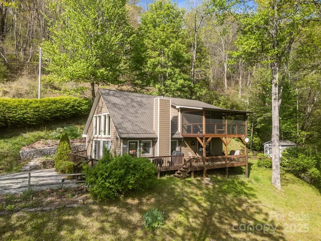 a view of a house with swimming pool and sitting area