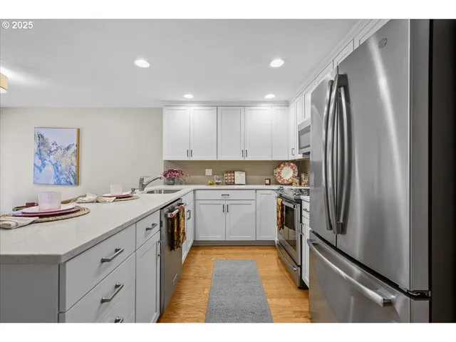a kitchen with a refrigerator stove and sink