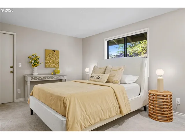 a bedroom with a bed and a painting on the wall