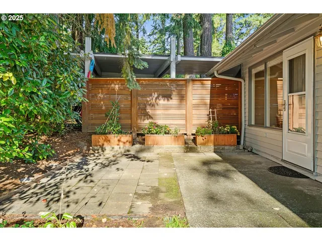 a view of a patio with table and chairs next to a yard