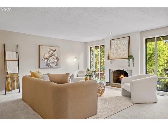 a living room with furniture a large window and a fireplace