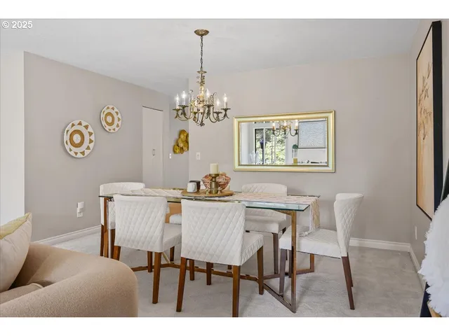 a view of a dining room with furniture and chandelier