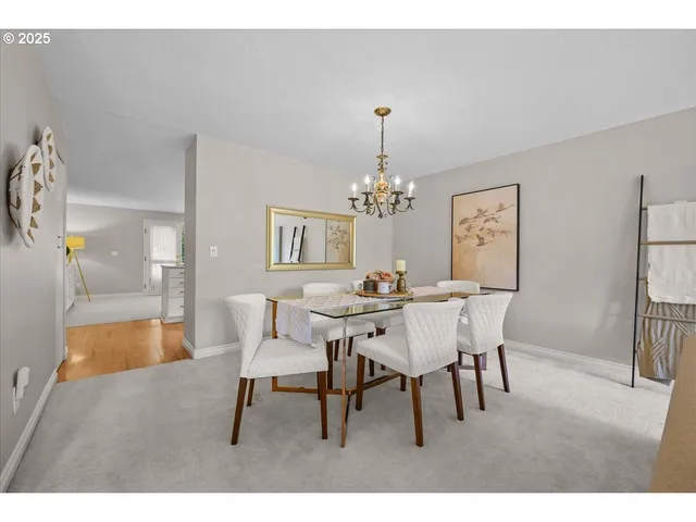 a view of a dining room with furniture and chandelier