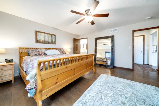a bedroom with a bed and a chandelier