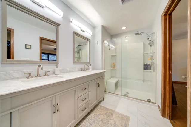 a bathroom with a granite countertop sink mirror and double