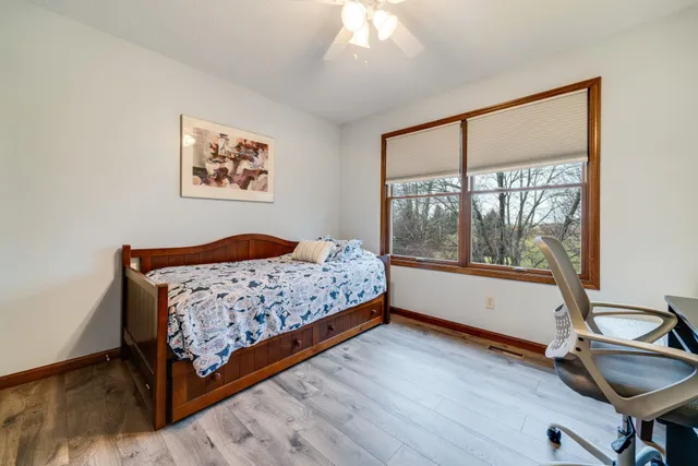 a bedroom with a bed and a large window