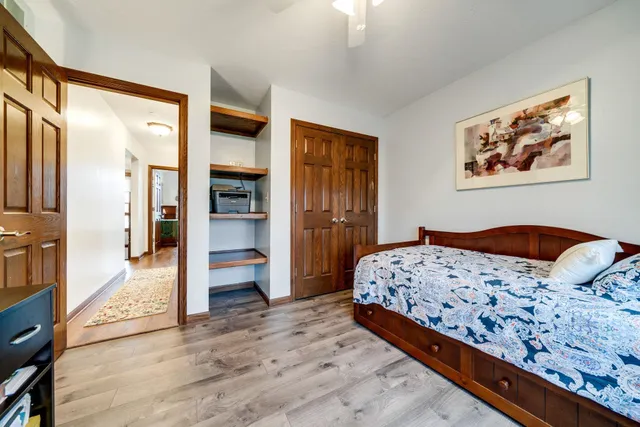 a bedroom with a bed and a large window