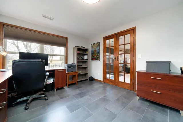 a view of workspace with furniture and windows