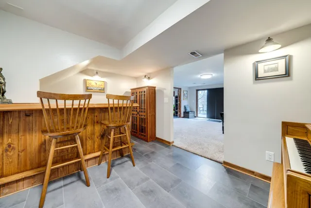 a view of a room with wooden floor windows and kitchen view
