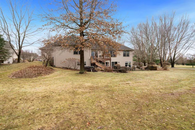 a view of a house with a yard covered in snow