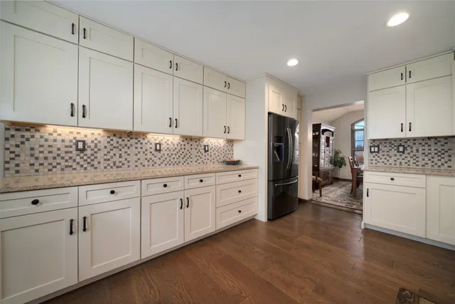 a kitchen with white cabinets and stainless steel appliances