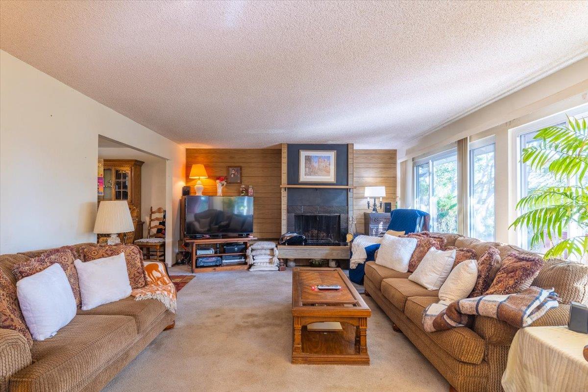 18117 Berta Canyon Road Salinas, CA 93907 - Photo 14 of 56 a living room with furniture fireplace and a large window