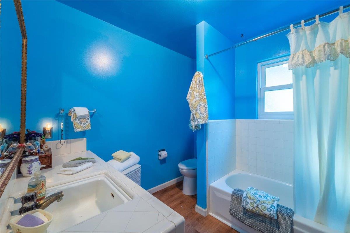 18117 Berta Canyon Road Salinas, CA 93907 - Photo 30 of 56 a bathroom with a sink a toilet and mirror