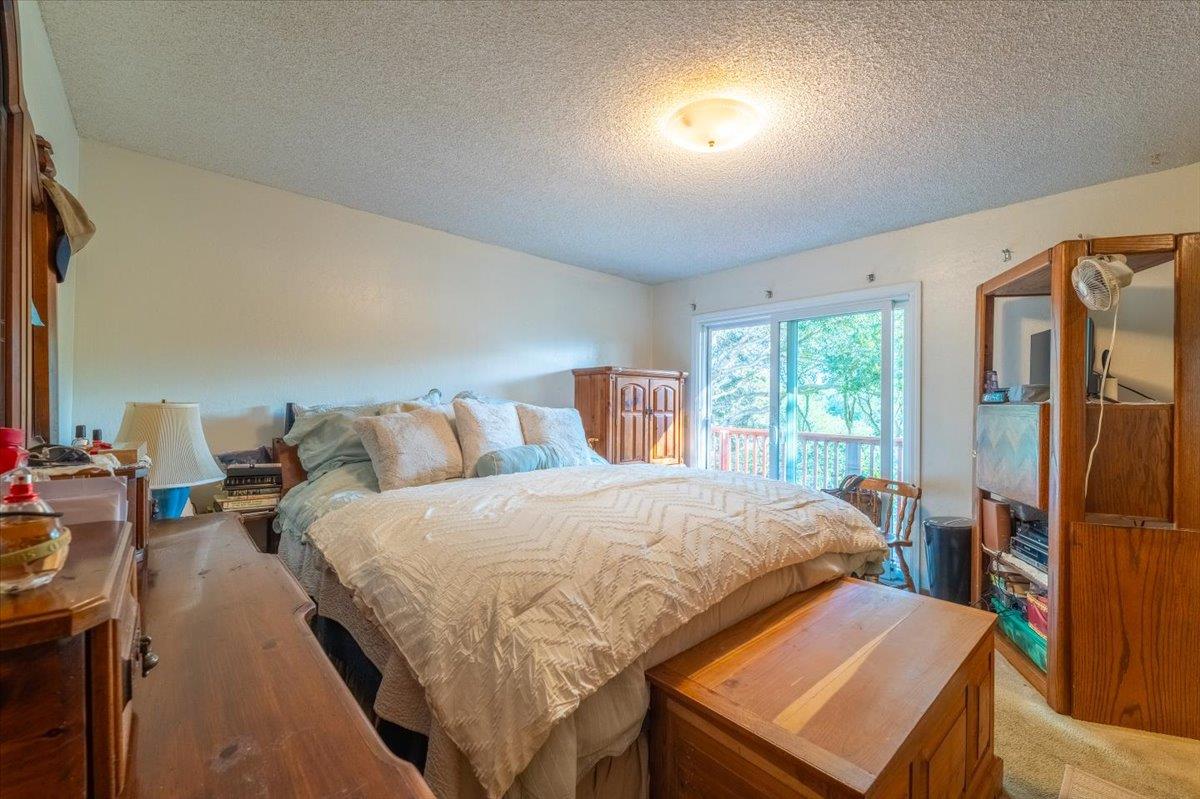 18117 Berta Canyon Road Salinas, CA 93907 - Photo 31 of 56 a bedroom with a bed and wooden floor