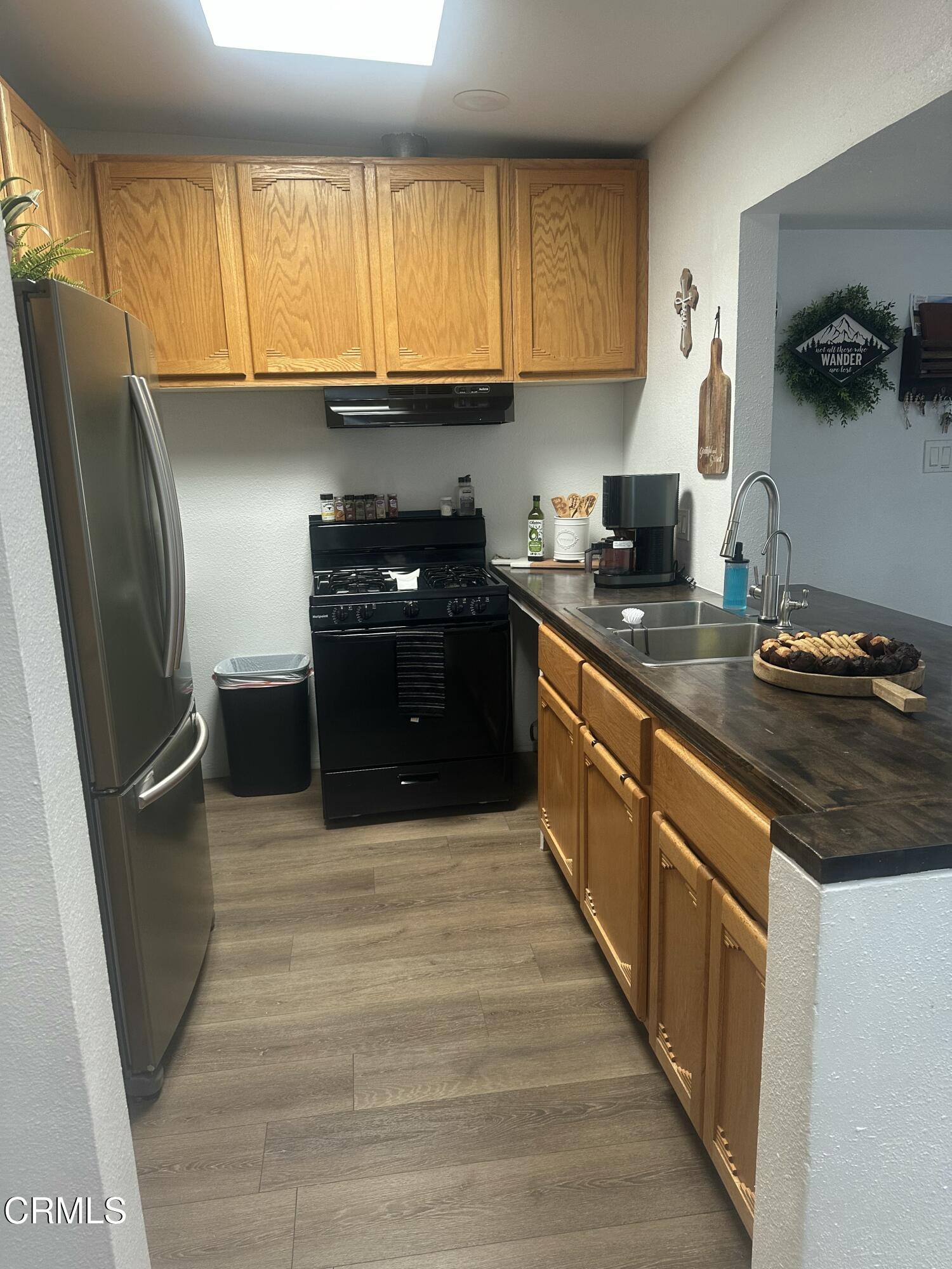 5246 Longfellow Way Oxnard, CA 93033 - Photo 4 of 15 a kitchen with stainless steel appliances granite countertop a sink stove and refrigerator