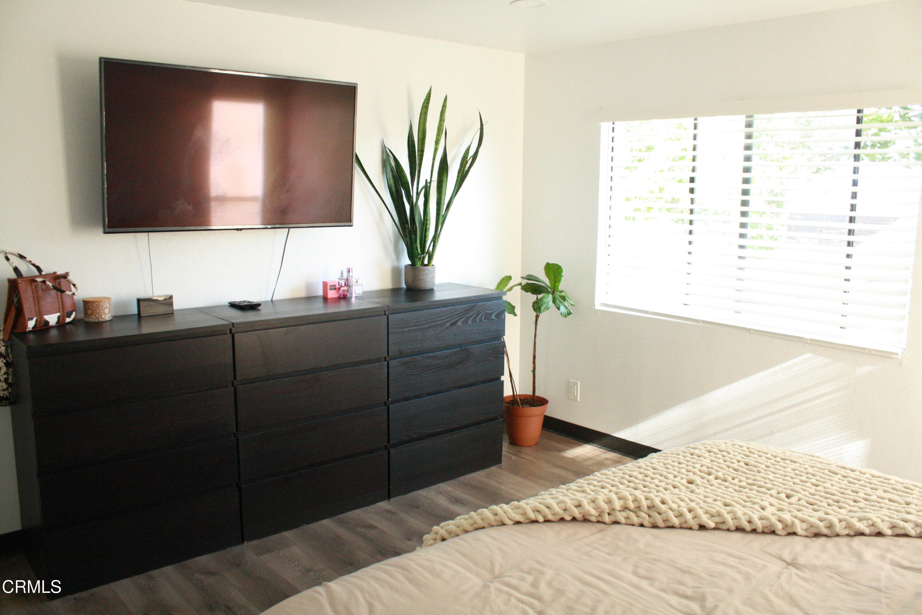 5246 Longfellow Way Oxnard, CA 93033 - Photo 7 of 15 a bedroom with a bed cabinet and mirror