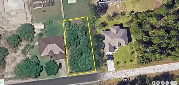 an aerial view of a residential houses with outdoor space