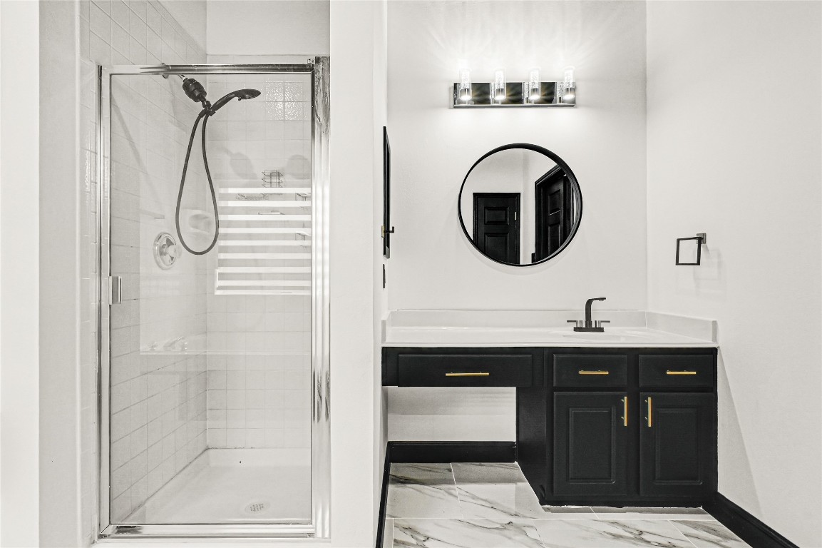 11915 Helene Court Pinehurst, TX 77362 - Photo 25 of 33 a bathroom with a sink a mirror and a shower