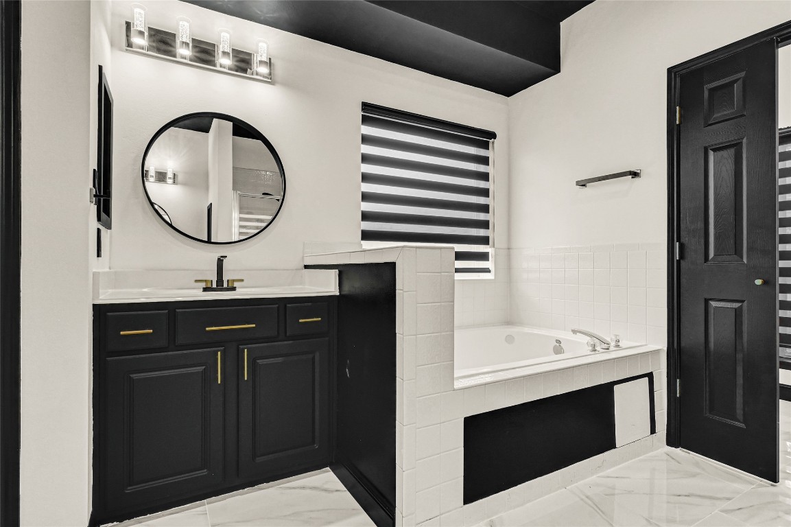 11915 Helene Court Pinehurst, TX 77362 - Photo 26 of 33 a bathroom with a sink and a mirror