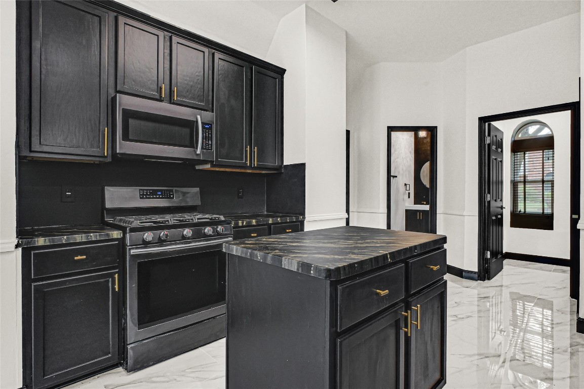 11915 Helene Court Pinehurst, TX 77362 - Photo 5 of 33 a kitchen with stainless steel appliances granite countertop a stove microwave and sink