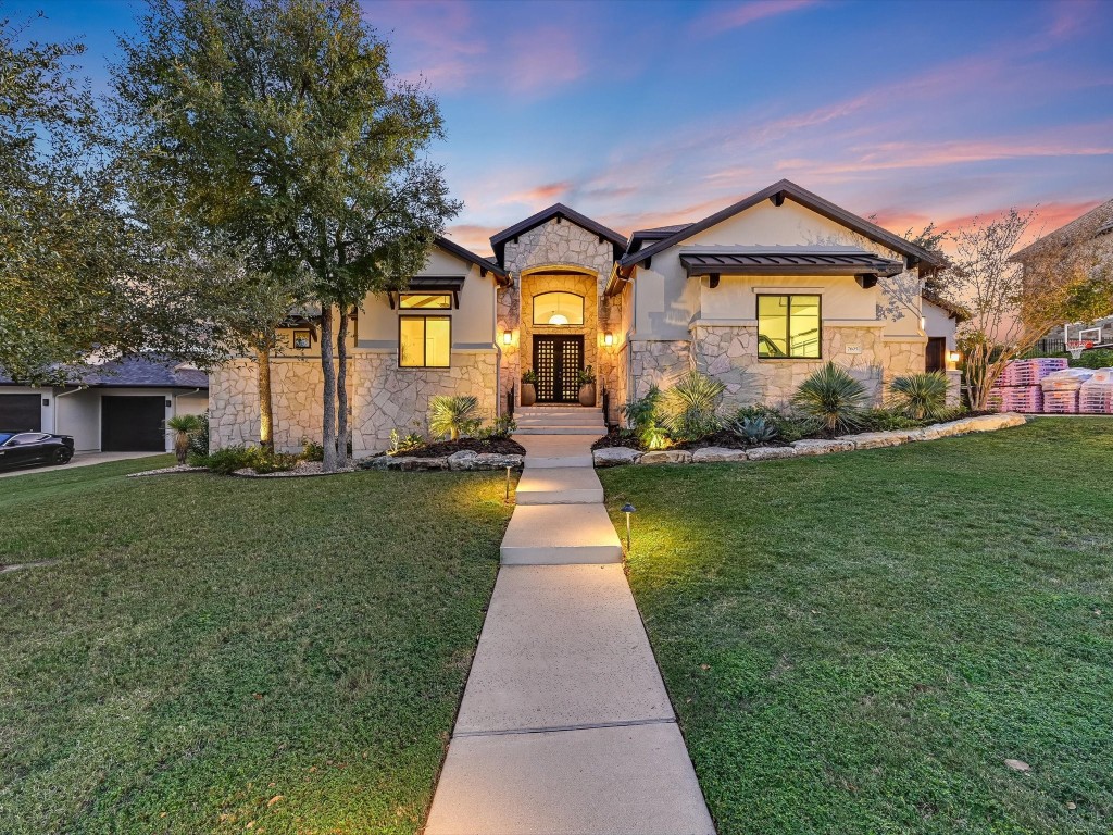 7605 Lazy River Cove Austin, TX 78730 - Photo 1 of 40 a front view of a house with garden