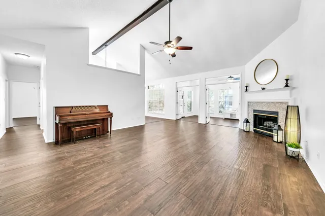 a kitchen with stainless steel appliances granite countertop a sink a stove a refrigerator cabinets and wooden floor