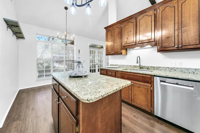 a view of a livingroom with wooden floor and a ceiling fan