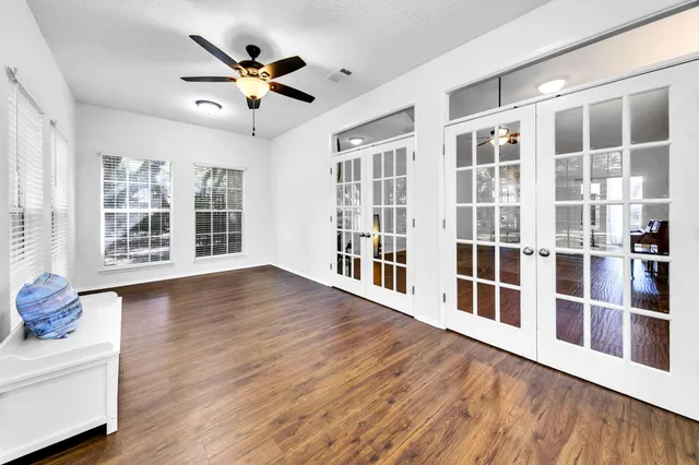 wooden floor in an empty room with a window