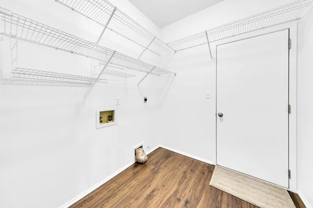 a bathroom with a granite countertop double vanity sink a mirror and a bathtub