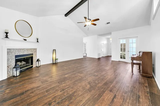 a view of a yard with plants and trees