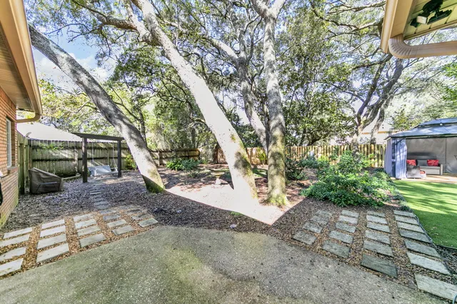 a backyard of a house with barbeque oven fire pit table and chairs