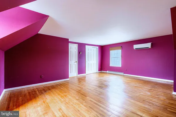 a view of an empty room with a ceiling fan